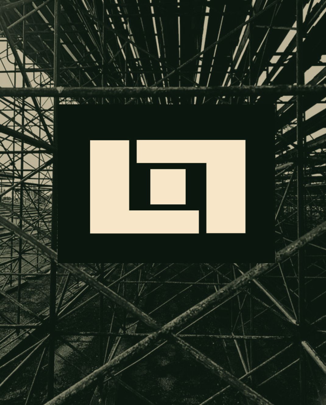 The Co.LLab™ mark on a black panel hung in steel scaffolding — the storefront of The .LLab